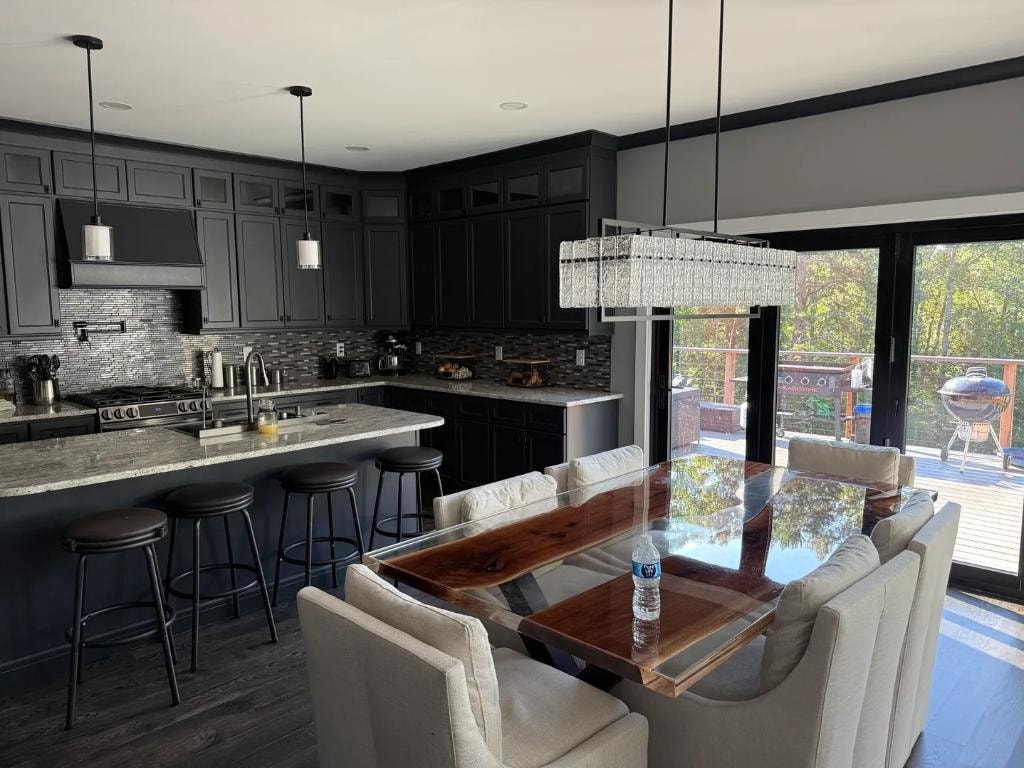 Dark kitchen remodel with island and dining area by Cornerstone KB Pro
