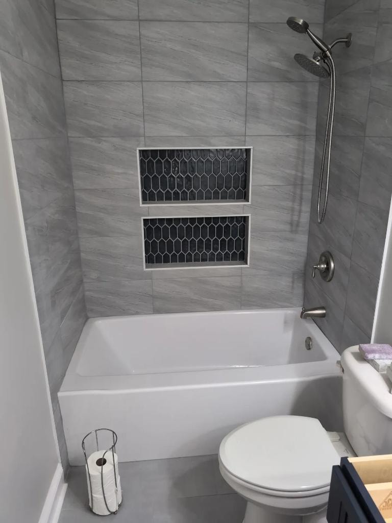 Gray tile bathroom renovation with tub by Cornerstone KB Pro